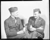 Two soldiers drinking from 1/2-pint milk containers