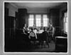 Family seated around dining room table, photograph part 2