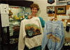 Judy Devers displays merchandise in "The Emporium", a gift shop run by salaried women on a volunteer basis raising funds for charity.