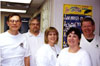 White Shirt Day is celebrated annually to commemorate the day on which General Motors recognized the United Auto Workers as the bargaining agent for their workers following a 36-day sit-down strike, the main focus of which was Flint, MI.  That day was February 11, 1937.  White shirts are worn because it was customary for managers to wear white shirts and ties while workers wore blue work shirts.  The wearing of white shirts signified that the workers on the line were just as good as the bosses.  Subjects are, from left to right: Jim Stroud, Tom Wheelock, Unknown, Doreen Howard, Tim Hansen.