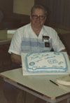 Richard Sanborn shows of the cake at his retirement party.