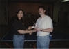 Renida (RT) Taylor giving a trophy to a ping-pong champion following an event conducted by the Recreation Committee.