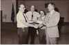 Fisher Body Plant Manager Frank Shotters (on the right) receives a contributon check for a charity event. Subjects are, from left to right: Unknown (possibly Lloyd Cain – former Local 602 President), John Rosendahl, Mike Clark, Frank Shotters (Plant Manager).