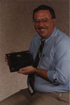 John Rosendahl posing with his plaque, received for his service to the Cystic Fibrous Foundation.