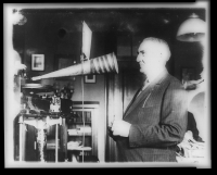 Warren G. Harding speaking into a recording apparatus.