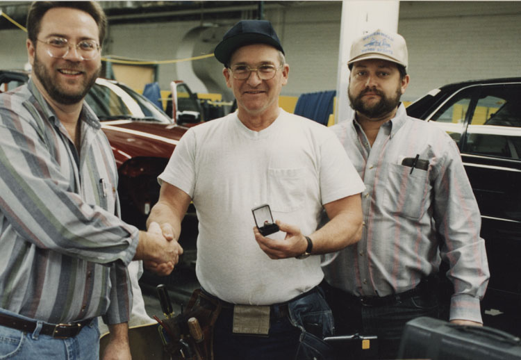 image of Subjects are, from left to right: Garry Bernath (Local 602 President), Al Staley, Rusty Zeigler (UAW Bargaining Committee).  Zeigler and Bernath are presenting Al Staley with a  UAW Local 602 ring . Staley has achieved twenty-five years of service.  